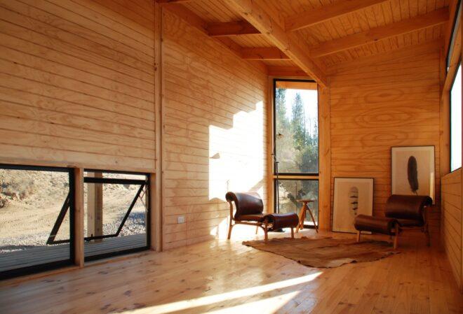 living area of a house with wood accents and windows letting in natural light