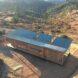 a rectangular house with solar panels on the roof
