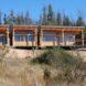 a rectangular house with windows atop a hill