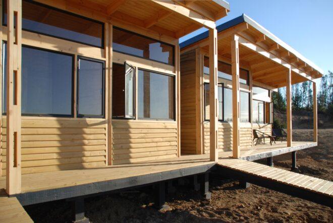 the front of a house with wood facade and windows