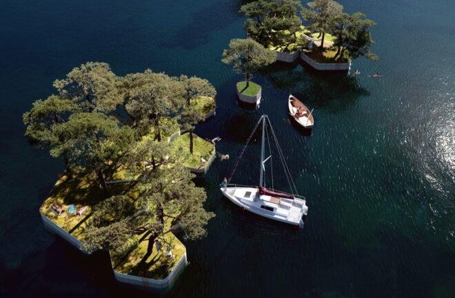 rendering of tree-covered islands near a boat
