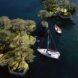 rendering of tree-covered islands near a boat