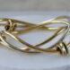 gold bangle bracelet on marble stand