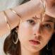 person wearing gold hoops and gold bracelets