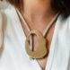 large statement necklace with gold oval pendant