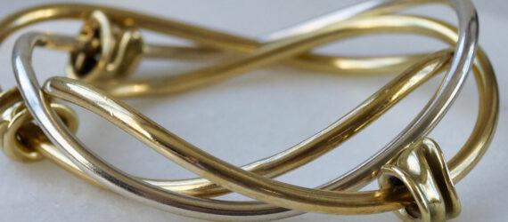 gold bangle bracelet on marble stand