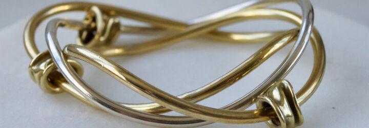 gold bangle bracelet on marble stand