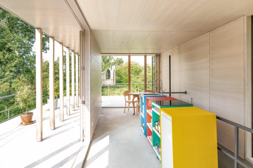 colorful cabinets against a light wood wall