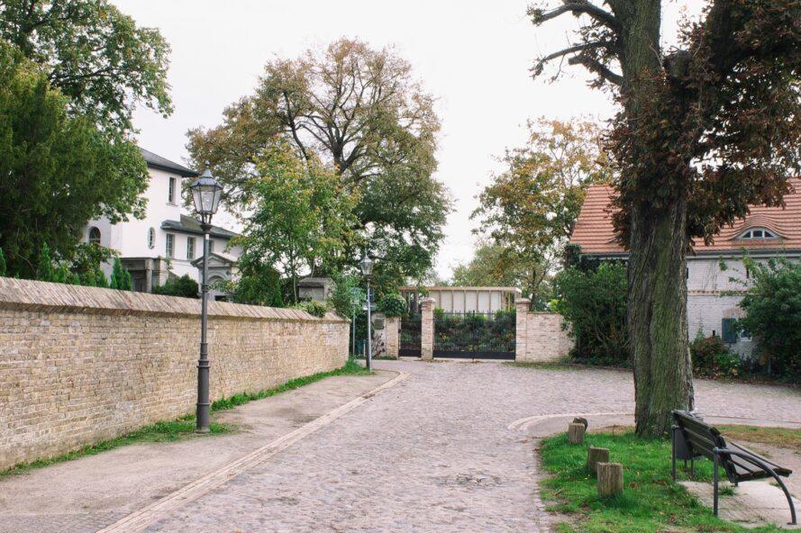 long pathway leading to a concrete home