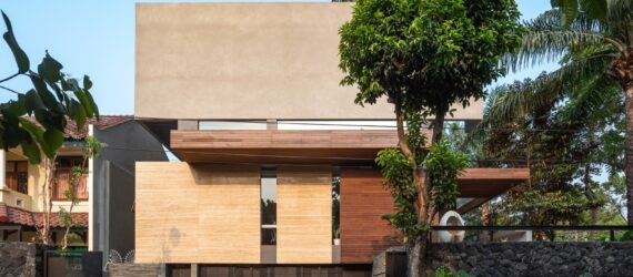 a multi-story home with a facade composed of several different materials, including both light and dark colored wood