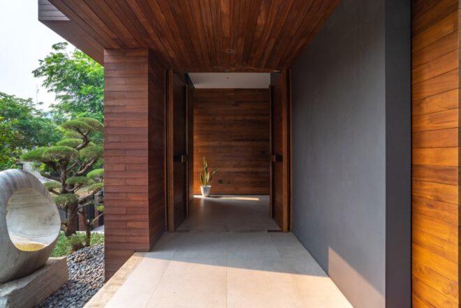 an indoor/outdoor hallway featuring dark wood accents