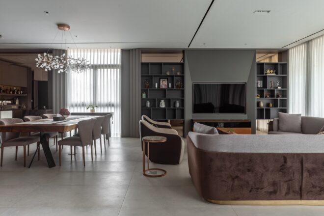 a living area with table, chairs, sofas and TV