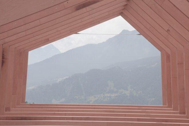geometric window revealing views of mountains