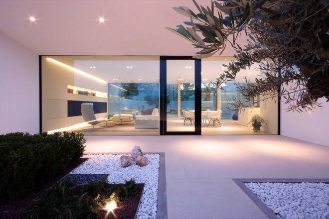 patio leading to glass door of white villa