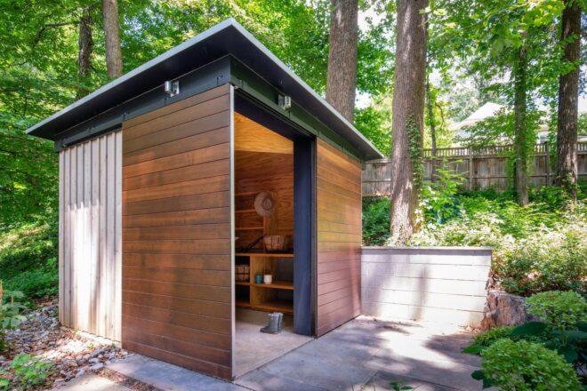 small backyard shed with sliding wooden doors