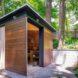 small backyard shed with sliding wooden doors