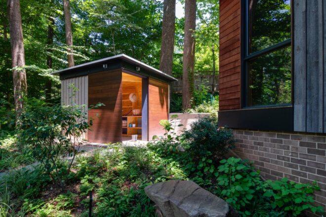 small wooden shed next to a main home