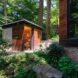 small wooden shed next to a main home