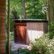 small structure surrounded by woodland