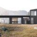 rendering of dark wood home with full-height windows and sliding glass doors
