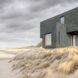rendering of dark gray home with perpendicular volumes stacked on top of each other