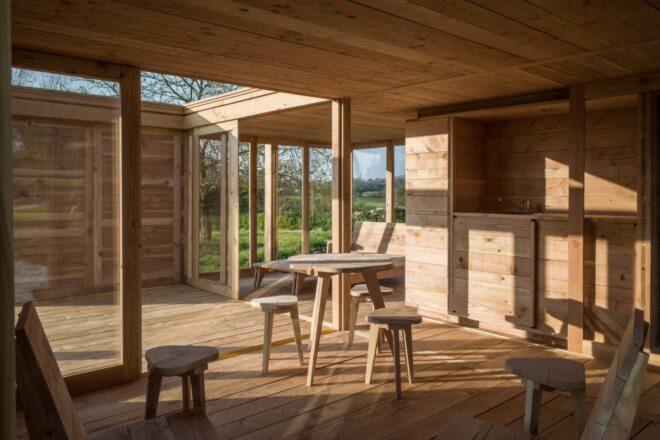 wood tiny home with wood furnishings and open-air courtyard