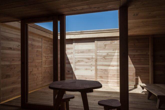 hightop wooden table in front of open-air courtyard