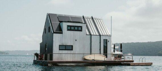 side of floating home with rooftop solar panels
