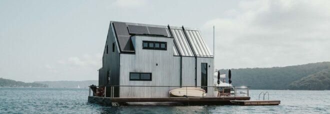 side of floating home with rooftop solar panels