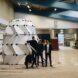 people building a full-size pod model with white panels