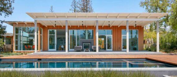 front of home with elongated swimming pool