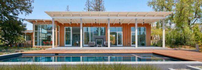 front of home with elongated swimming pool