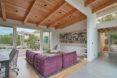 large living space with wooden ceiling and purple couch