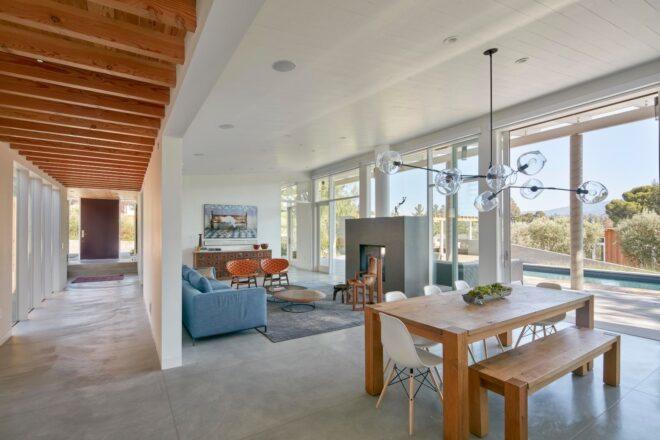open plan living room with blue couch and small dinette set