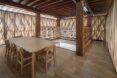 interior of a wooden library with bookshelves, tables and chairs