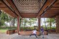 two kids playing under an elevated wooden building