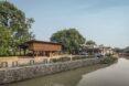 a view of an elevated wooden library from the river