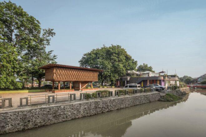 a view of an elevated wooden library from the river