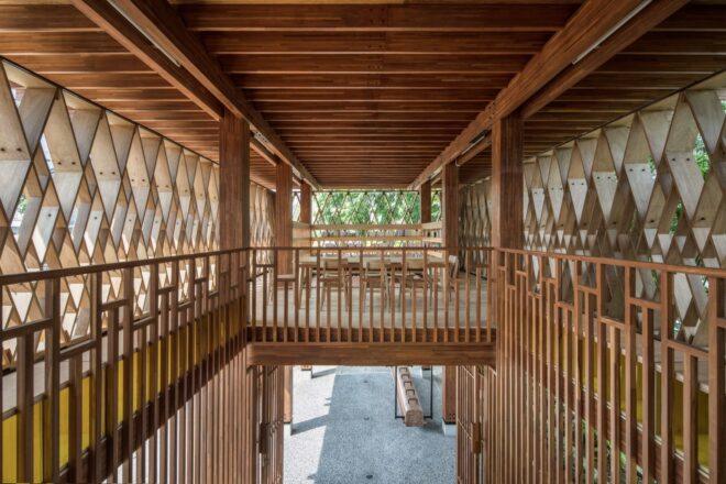 a view from the top of the staircase in the wooden elevated library