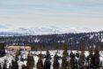 wood cabin on snowy, mountainous landscape