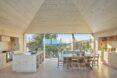 all-wood interior space with large windows, wood dining table and wood kitchen island