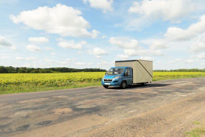 truck with camper driving down the highway