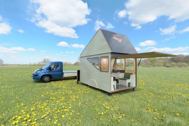 blue truck with cabin on green setting