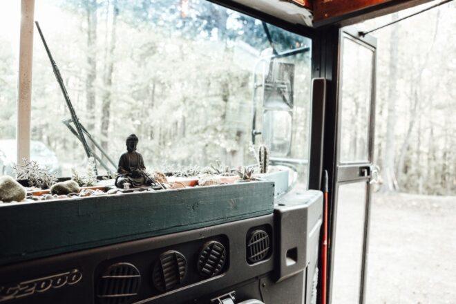 small garden space on the dashboard of a converted bus