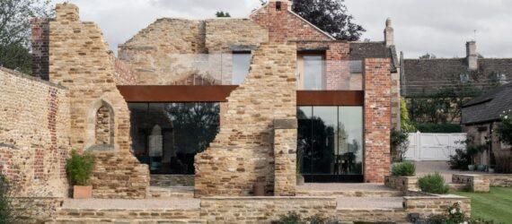 modern glass and metal structure inside broken brick exterior walls