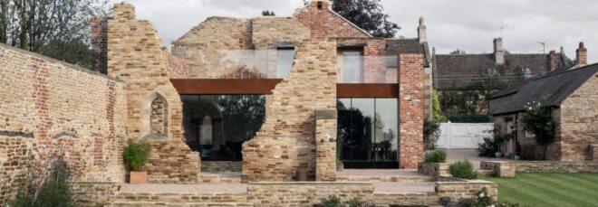 modern glass and metal structure inside broken brick exterior walls