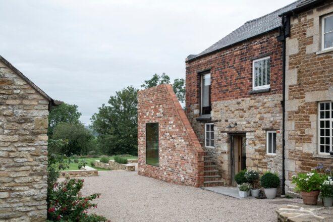 home surrounded by partially destroyed brick walls