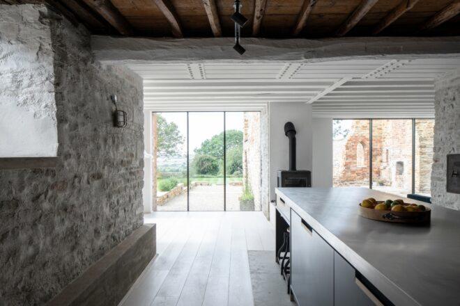 kitchen island across from an exposed brick wall