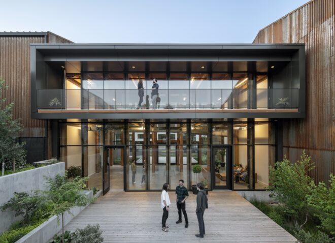 people standing outside glass atrium