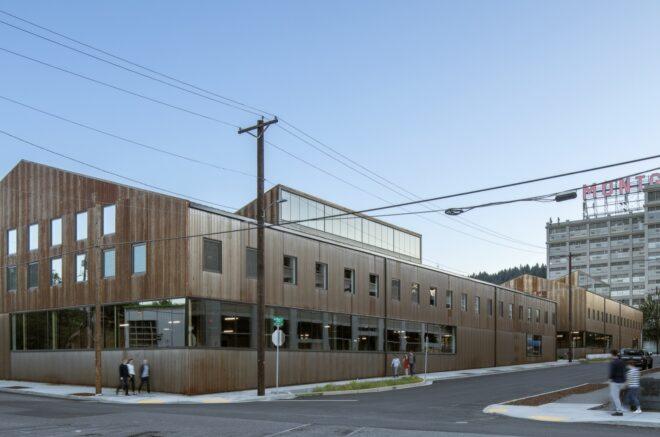 long weathered steel industrial building with gabled roof